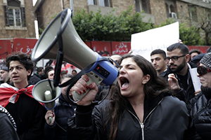 A Lebanese anti-government demonstrator yells in front of the central bank building in Beirut.

(AP)