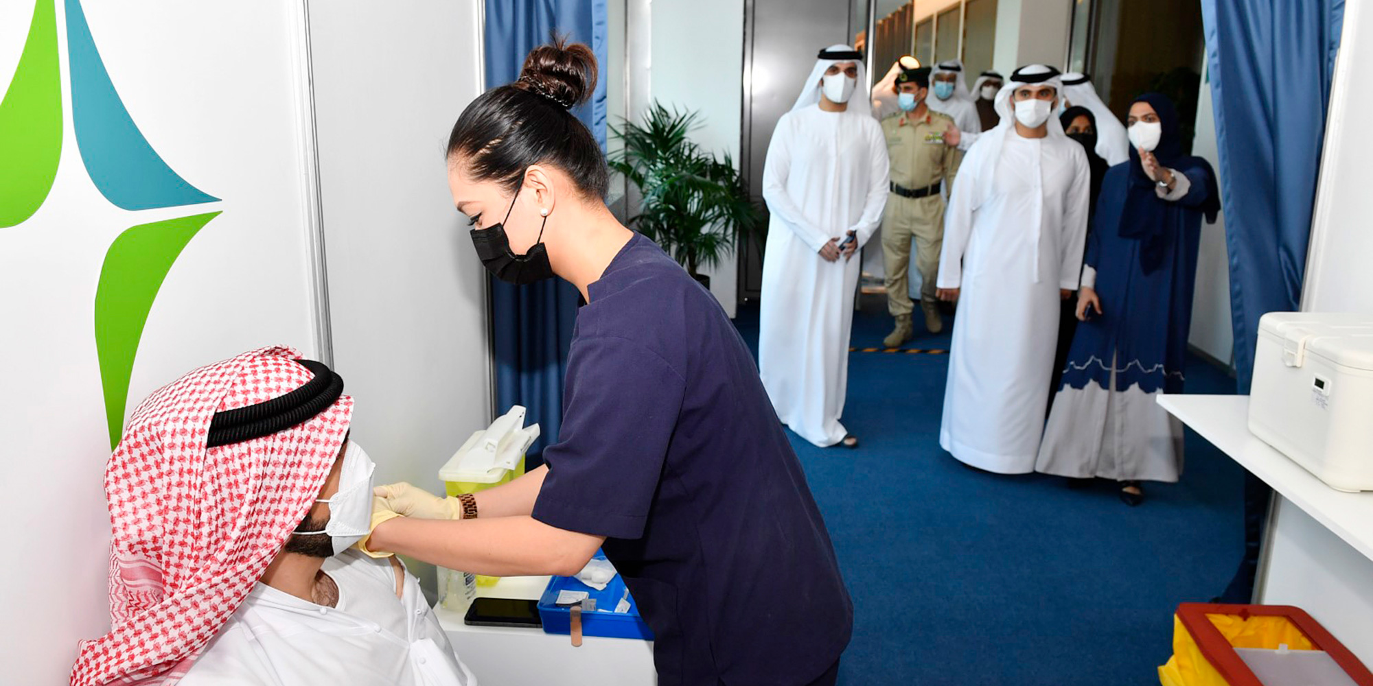 Sheikh Mansoor is briefed on the vaccination drives organized by health care centres in Dubai