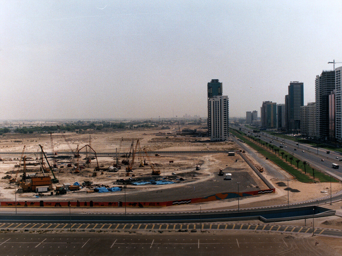 1997: Aerial view of the construction site of Emirates Towers on Sheikh Zayed Road in Dubai. Construction began in 1996, and the towers opened in 2000.